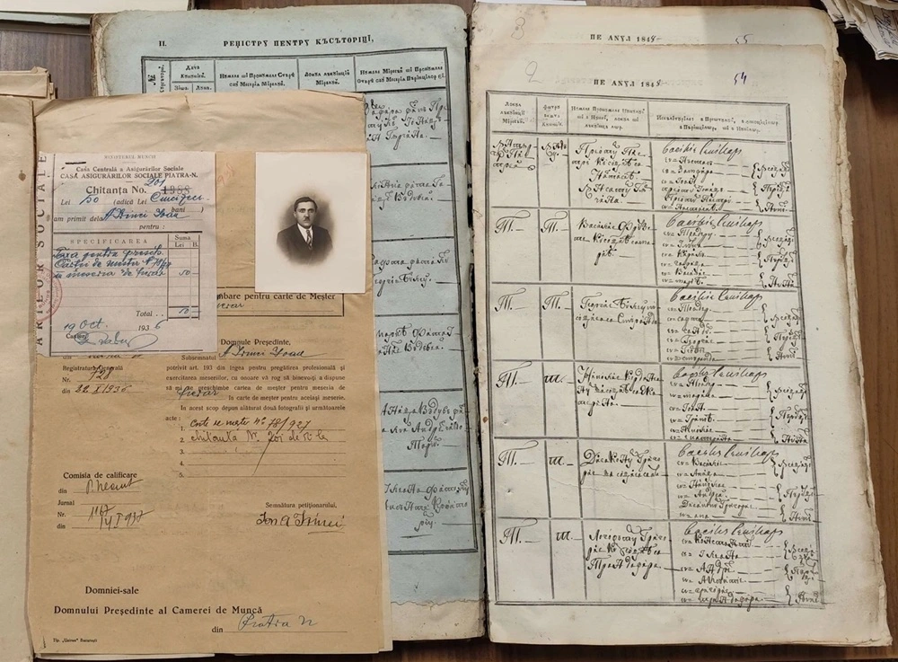 Historical registers and documents alongside a family photograph